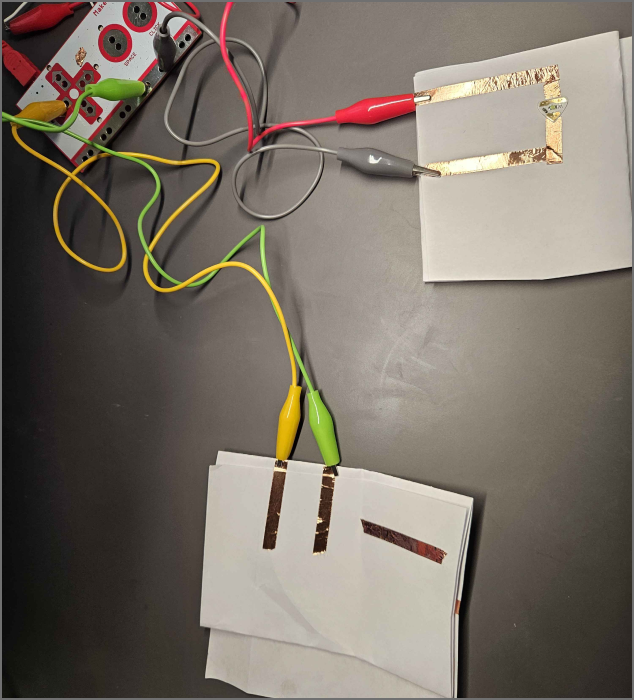 creating a switch by connecting both the switch to ground and a button press, and by grounding the LED light while using aligator clips to get power from the computer