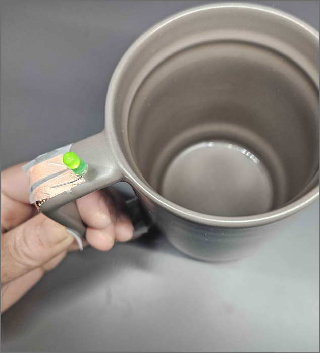 a final look at the cup lighting up when the user hold it by the handle